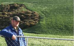 Farmer leaning on gate